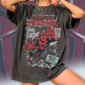 May include: A white ceramic mug with a black handle and the text "But First, Coffee" in a bold, black font. The mug is set against a blurred background, suggesting a cozy setting.