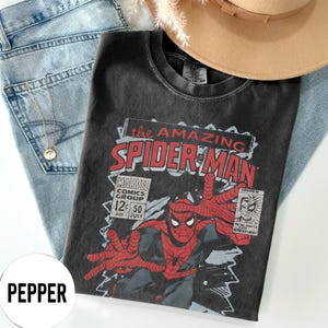 May include: A white ceramic mug with a black handle and the text "But First, Coffee" in a black, handwritten-style font. The mug is on a white surface.