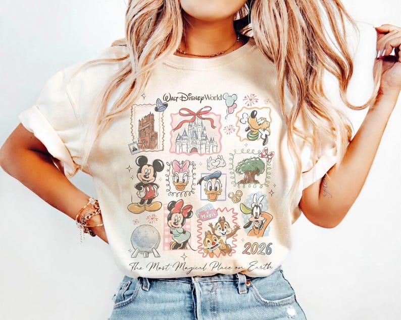 May include: Cream-colored t-shirt featuring a colorful collage of Disney characters and landmarks. The design includes Mickey Mouse, Minnie Mouse, Donald Duck, and Chip and Dale, along with the text "Walt Disney World" and "The Most Magical Place on Earth."