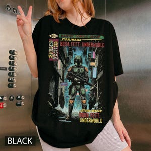 Puede incluir: Camiseta negra con un gr&aacute;fico de Boba Fett de Star Wars: Underworld. El dise&ntilde;o incluye el texto "Marvel Comics Group Star Wars Boba Fett: Underworld" en estilo c&oacute;mic. La camiseta es negra.
