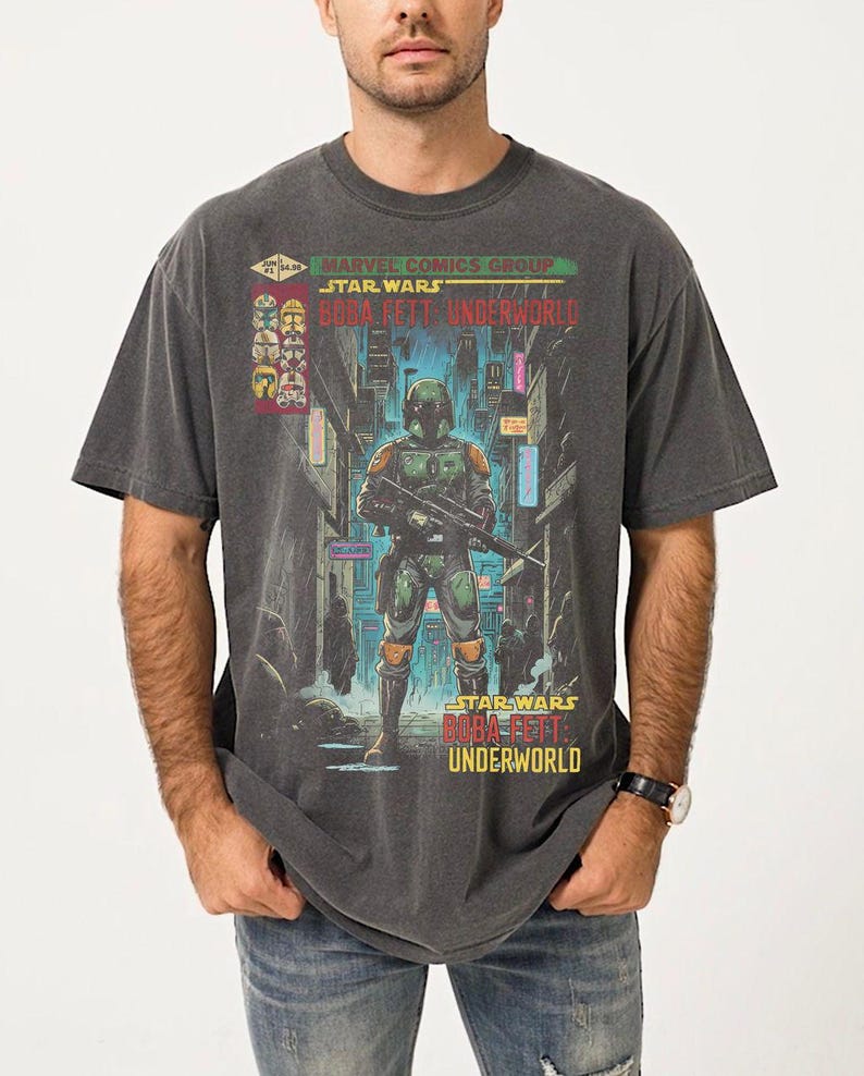 Puede incluir: Camiseta gris oscuro con un gr&aacute;fico de Star Wars Boba Fett Underworld. El dise&ntilde;o incluye a Boba Fett con su armadura, sosteniendo un arma, con el texto "Marvel Comics Group Star Wars Boba Fett Underworld".