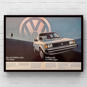 May include: Vintage Volkswagen advertisement featuring a silver Rabbit Diesel car. The image includes the Volkswagen logo and text that reads "How the Rabbit works: The Diesel" and "Nothing else is a Volkswagen."