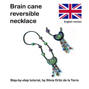May include: A reversible necklace made with colorful beads and a brain cane pendant. The pendant has a green and black pattern on one side and a black and white pattern on the other side. The necklace is a step-by-step tutorial by Silvia Ortiz de la Torre.