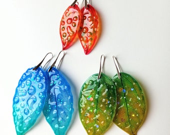 Colorful earrings, translucent leaves with waterdrops