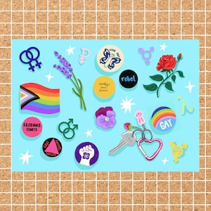 May include: A collection of colorful LGBTQ+ themed stickers, pins, and a keychain on a light blue background. The items include a rainbow flag, floral elements, and the word "GAY" on a rainbow pin. Other pins have text like "Lesbians Ignite" and "Rebel".