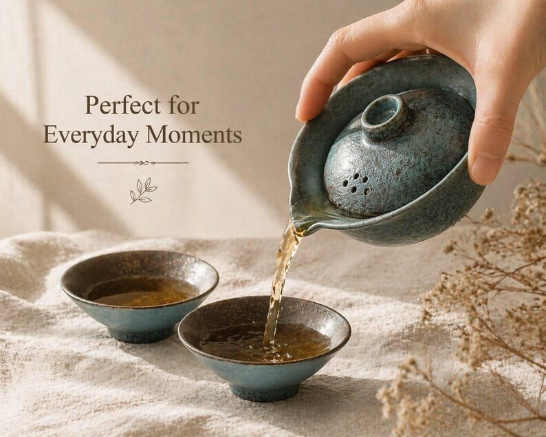 May include: A teal ceramic tea set with a teapot pouring tea into two small bowls. The teapot has a lid with small holes. The text "Perfect for Everyday Moments" is visible in the image.