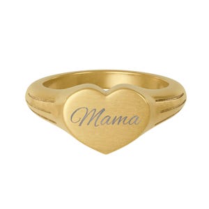 May include: A gold ring featuring a heart-shaped face with the word "Mama" engraved in cursive. The ring has a brushed finish and a thick band with etched lines. A stylish piece of jewellery.
