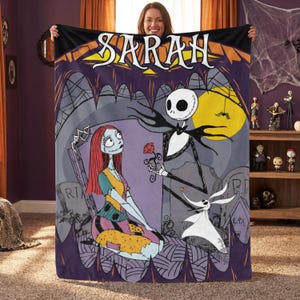 May include: A purple and black throw blanket featuring a scene from The Nightmare Before Christmas. The blanket depicts Jack Skellington offering a rose to Sally, with Zero the ghost dog nearby. The name "SARAH" is displayed across the top.