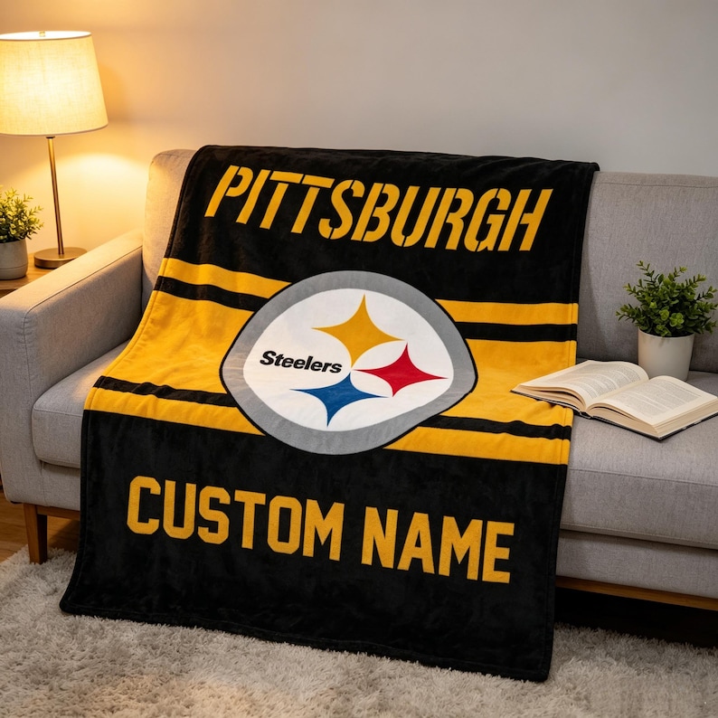 May include: A black and yellow fleece blanket featuring the Pittsburgh Steelers logo in the center. The word PITTSBURGH is printed in large yellow letters at the top, and the words CUSTOM NAME are printed in yellow letters at the bottom.