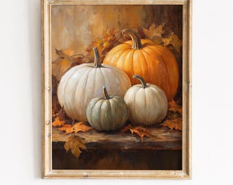 May include: A framed oil painting depicting a still life of four pumpkins in varying sizes and colours, including one large orange pumpkin, two white pumpkins, and one smaller sage green pumpkin, all resting on a wooden surface with fallen autumn leaves.