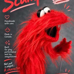 Puede incluir: Una marioneta de monstruo de color rojo brillante y pelo largo con grandes ojos blancos y negros. La imagen incluye el texto: Say hello to Scamp, A little monster with a BIG personality, Handmade with care, Made in Canada, Built for play, performance and big imaginations, Not just a puppet... A character, MonstersPlay, HANDMADE PUPPETS REAL CHARACTERS, Meet Scamp on Etsy.