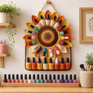 May include: A sunflower-shaped crochet wall organizer featuring multiple pockets holding various colorful nail polish bottles. The organizer has a brown center, yellow and orange petals, and a rectangular base. A wooden tray holds more nail polish.