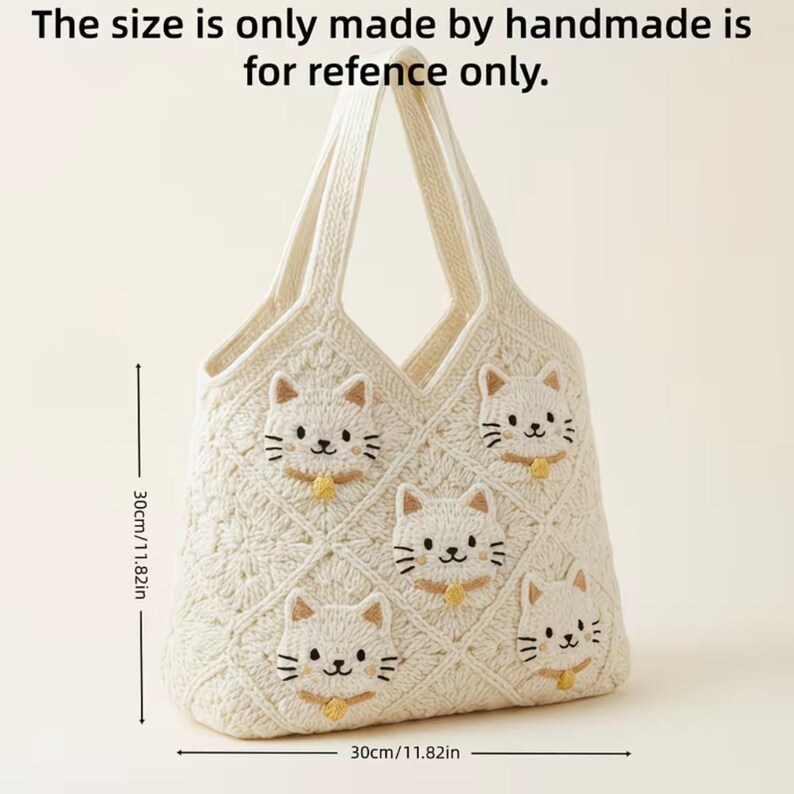 May include: Cream-colored, handmade tote bag with a cat face design. The bag is approximately 11.82 inches wide and 11.82 inches tall. The text on the image says, "The size is only made by handmade is for refence only."
