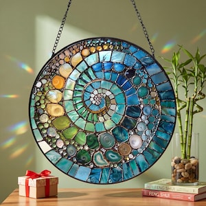 May include: A set of three ceramic mugs with a speckled, matte finish. The mugs are in shades of cream, light gray, and dark gray. Each mug has a simple, minimalist design and a rounded handle. The mugs are likely for coffee or tea.