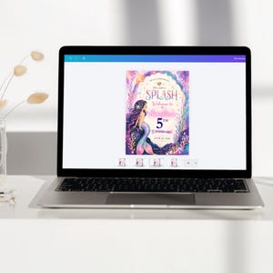 May include: A laptop displays a colorful invitation with a mermaid theme. The invitation reads "Splash" and "Welcome to Amelia's 5th Birthday." The mermaid has long purple hair and a blue and teal tail. The background is a mix of pinks, purples, and blues.