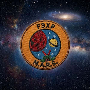 May include: Embroidered patch with a space theme. The patch features a red planet, a yellow planet with a ring, and a green alien. The text "F3XP" and "M.A.R.S." are also included. The background is a starry galaxy.