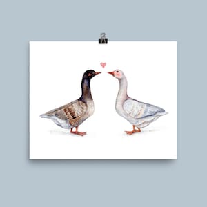 May include: A watercolor painting of two geese facing each other with a pink heart above them. The goose on the left is brown and gray, while the goose on the right is white with a pink beak.