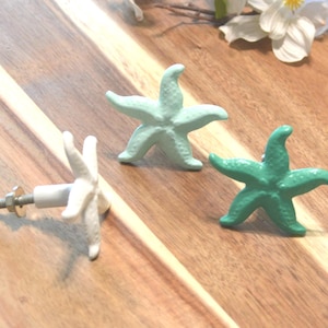 May include: A set of three ceramic mugs with a speckled, matte finish. The mugs are in shades of cream, light gray, and dark gray. Each mug has a simple, minimalist design, perfect for coffee or tea.