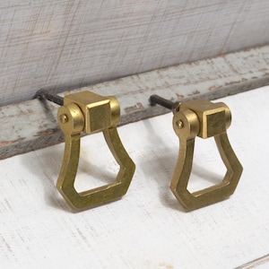 May include: A white ceramic mug with a black handle and the text "But First, Coffee" in a black, handwritten font. The mug is on a white surface.