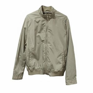 May include: A light tan jacket with a full zipper closure and a stand-up collar. The jacket has two front pockets and ribbed cuffs and hem. The jacket is made of a lightweight material.