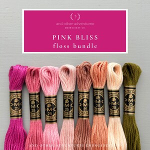 May include: A 'Pink Bliss' floss bundle with various shades of pink, peach, and olive green thread. The image includes a pink banner with the text 'Pink Bliss floss bundle' and 'and other adventures EMBROIDERY CO'. Each floss skein is labeled 'DMC 25'.