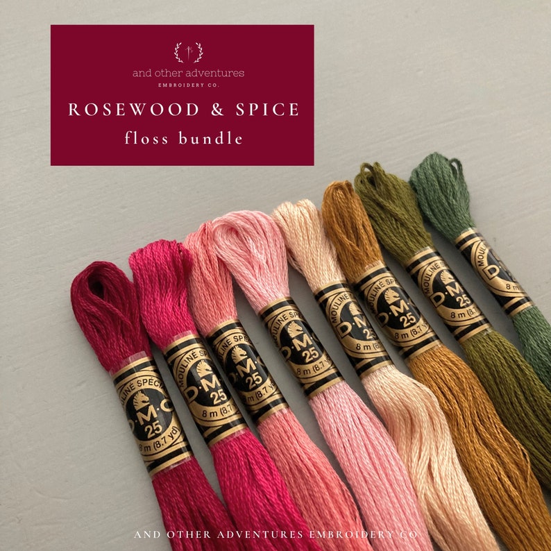 May include: A floss bundle containing eight spools of embroidery floss in shades of pink, red, orange, and green. The spools are labelled "DMC" and feature a horse logo. The text "Rosewood & Spice floss bundle" is printed on a burgundy background.