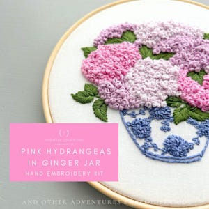 May include: A hand embroidery kit featuring pink hydrangeas in a blue and white ginger jar. The kit includes all the materials needed to create the embroidery, including embroidery floss, needles, and fabric.