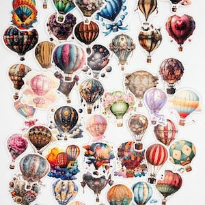 May include: A collection of numerous die-cut stickers featuring various hot air balloons in diverse colors, patterns, and artistic styles, including floral motifs, celestial themes, and striped designs, arranged in a scattered layout on a white background.