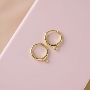 May include: A set of three ceramic vases in varying heights. The vases have a matte finish in shades of cream, beige, and brown. The tallest vase is approximately 10 inches high.