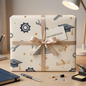 May include: A wrapped gift with a beige background and a pattern of tools, gears, graduation caps, and scrolls. The gift is tied with a beige ribbon and bow. A small card with the text "MICHAELBOStudio" is attached to the ribbon.