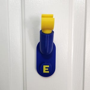 Personalized 3D printed toy brick  mini figure inspired wall hook. Use in a Kid's room, hall or cubby. Customizable initial and color.