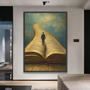 May include: An artistic painting depicts a person walking on a path formed by an open book. The path leads upwards against a blue and gold sky. The book's pages are detailed with text, and the artwork is framed in black.
