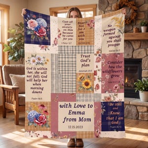 May include: A patchwork throw blanket featuring floral designs, plaid patterns, and inspirational quotes. The blanket includes a personalized message, "with Love to Emma from Mom," and the date 12.15.2023. The color palette includes shades of blue, pink, and beige.