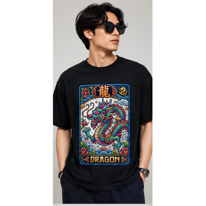 May include: Black t-shirt featuring a colorful dragon design with the word "DRAGON" at the bottom. The dragon is depicted in shades of blue, green, and red, with floral and wave-like elements. The shirt has short sleeves.