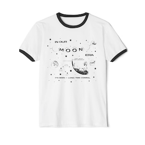 May include: A set of three ceramic mugs with a speckled, matte finish. The mugs are in shades of cream, light gray, and dark gray. Each mug has a simple, minimalist design and a rounded handle.