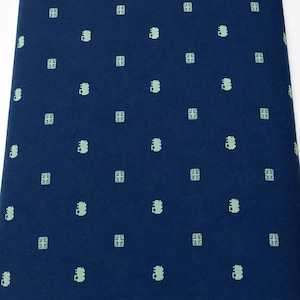 May include: A dark blue fabric featuring a repeating pattern of small, light green icons. The design consists of alternating rows of stylized Union Jack flags and small, rounded vehicle shapes arranged in a consistent grid across the surface.
