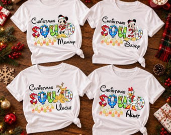 Puede incluir: Cuatro camisetas blancas de manga corta con el texto Christmas Squad. Cada camiseta muestra un personaje Disney diferente: Minnie Mouse, Mickey Mouse, Pluto o Daisy Duck, todos con ropa festiva y rodeados de luces navideñas de colores.