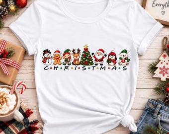 Camiseta con adorables personajes navideños, camiseta gráfica de Papá Noel, muñeco de nieve y reno, camiseta festiva para las fiestas, conjunto navideño familiar a juego.