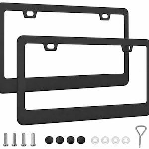 May include: Two black license plate frames with mounting hardware, including screws, screw caps, and washers. A metal tool is also included. The frames are rectangular with rounded corners and a matte finish.
