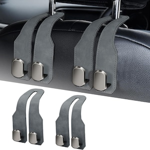 May include: Gray car seat headrest hooks with silver-colored metal hooks. The hooks are designed to hang items in a vehicle. The hooks are made of a soft, suede-like material.