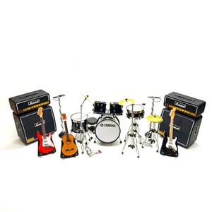 May include: A collection of miniature musical instruments, including electric and acoustic guitars, a drum kit with a Yamaha bass drum, and Marshall amplifiers. The set is designed to a small scale.