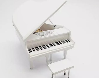 May include: A white grand piano with a matching bench. The piano's lid is open, revealing the keys and interior details. The keys are black and white. The piano and bench are set against a white background.