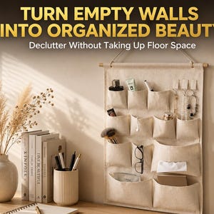 May include: A beige canvas wall hanging organiser with multiple pockets, suspended from a wooden rod. The text "TURN EMPTY WALLS INTO ORGANIZED BEAUTY" and "Declutter Without Taking Up Floor Space" is printed in gold and white above the organiser.