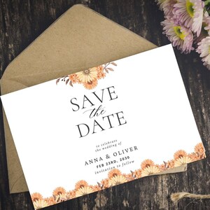 May include: A white wedding invitation with the text "SAVE the DATE" and floral accents. The invitation includes the names "ANNA & OLIVER" and the date "FEB 23RD, 2030". It is placed inside a brown envelope.