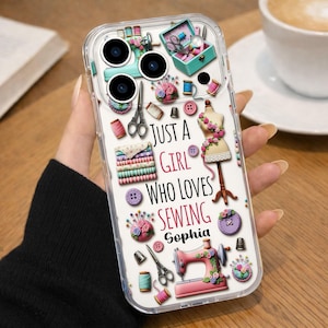 May include: Clear phone case featuring a sewing-themed design. The case includes illustrations of sewing tools, a dress form, and the text "Just a Girl Who Loves Sewing Sophia". The design incorporates pink, teal, and purple elements.