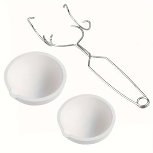 May include: Two white ceramic crucibles and a metal crucible holder. The crucibles are round with a small spout. The holder is made of silver-coloured metal and has a handle for easy use.