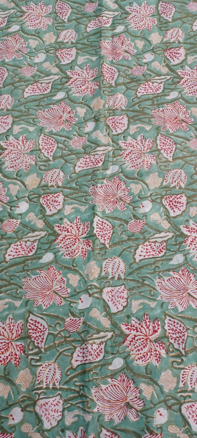 Indian botanical block print fabric by yard
Vintage Style Indian Block Print Fabric featuring Red Lotus Flowers, Botanical Leaves and Nature Inspired Vine Design on Premium Cotton Fabric for Clothing, Bedding and Handmade Accessories.
Handmade Indian Botanical Cotton Fabric featuring Red Floral Lotus Blooms and Green Vine Pattern, Perfect for Sewing Dresses, Table Runners, Napkins, Tote Bags and Quilting Projects.