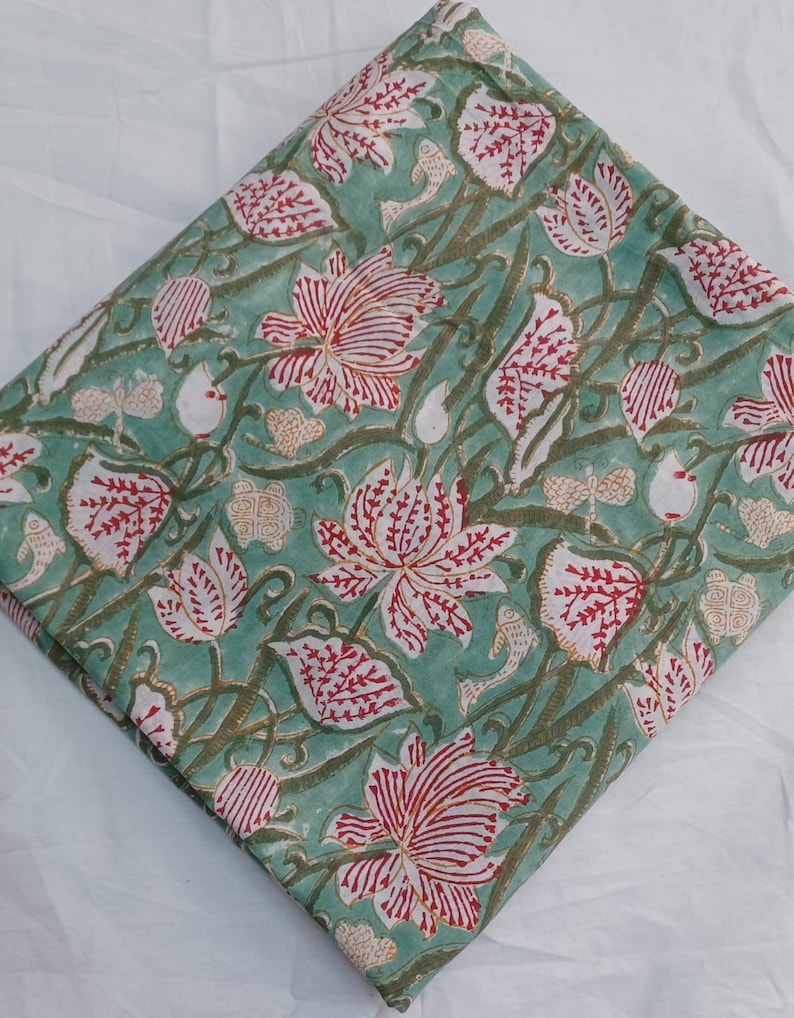 Decorative Indian cotton fabric for curtains and pillows
Traditional Handmade Block Print Fabric with Elegant Red Flowers, Botanical Leaves and Vintage Vine Pattern on Green Cotton Fabric for Dressmaking, Patchwork, Quilts and Farmhouse Home Decoration.
Authentic Indian Cotton Fabric by the Yard featuring Hand Block Printed Floral Lotus Motif, Nature Inspired Botanical Design for Sewing Apparel, Tablecloths, Pillow Covers and Interior Decorating.