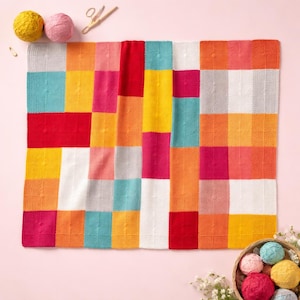 May include: A colorful, handmade crochet blanket with a patchwork design. The blanket features squares in various colors, including red, yellow, pink, orange, and blue. The image also shows yarn balls, scissors, and a basket of yarn balls.