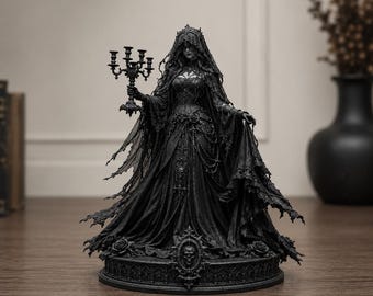 May include: A black figurine of a figure in a long, flowing gown and veil, holding a five-armed candelabra. The base features a skull emblem and rose details. The entire piece is monochromatic black with intricate textures on the fabric and lace.